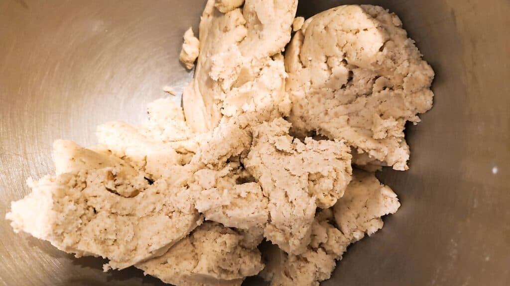 It's okay if snowball cookie dough is crumbly! It should stick together when you press it together with your fingers! Ours was gluten-free and we used vegan palm shortening but it still stuck together.